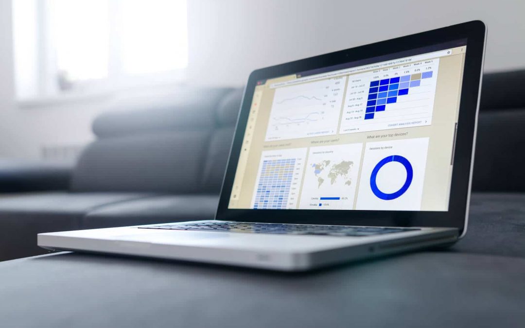 laptop with sales figures on table
